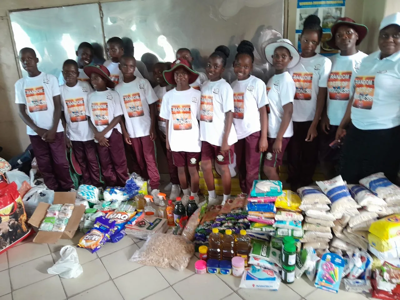Successvale learners and adults standing behind donated supplies